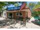 Inviting exterior of an old fashion ice cream shop with an American flag and outdoor seating area at 1100 Gaylord St, Denver, CO 80206