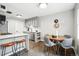 Modern eat-in kitchen features stainless steel appliances, gray cabinetry, breakfast bar and a contemporary dining area at 1100 Gaylord St, Denver, CO 80206