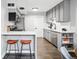 Modern kitchen with stainless steel appliances, a breakfast bar, and ample counter space for culinary enthusiasts at 1100 Gaylord St, Denver, CO 80206