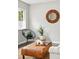 Stylish living room features a round mirror, leather ottoman, and a comfortable chair for a cozy atmosphere at 1100 Gaylord St, Denver, CO 80206