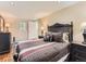Inviting bedroom with striped duvet, wood floors and bright, recessed lighting at 3265 S Ogden St, Englewood, CO 80113