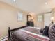 Comfortable bedroom with tan walls, black bed frame and warm lighting at 3265 S Ogden St, Englewood, CO 80113