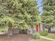 Charming home exterior featuring mature trees and a bright red front door at 3265 S Ogden St, Englewood, CO 80113