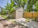 Exterior view of detached garage with tan siding and an adjacent fenced yard at 3265 S Ogden St, Englewood, CO 80113