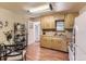 Cozy eat in kitchen featuring wood cabinets, wood floors, and white appliances at 3265 S Ogden St, Englewood, CO 80113