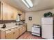 Kitchen featuring wood cabinets, wood floors, and white appliances at 3265 S Ogden St, Englewood, CO 80113