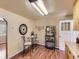 Eat-in kitchen with wood floors, a table with chairs, and view to appliances at 3265 S Ogden St, Englewood, CO 80113