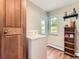 Convenient laundry room with washer, shelving and bright windows at 3265 S Ogden St, Englewood, CO 80113