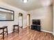 Bright living room with wood floors, archways, white refrigerator, and neutral wall color at 3265 S Ogden St, Englewood, CO 80113