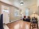 Bright living room featuring wood floors, two windows with blinds, and a white door at 3265 S Ogden St, Englewood, CO 80113