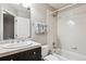 Bathroom featuring a shower and bathtub combo, vanity with storage, and neutral decor at 150 S Harrison St # 9, Denver, CO 80209