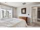 Comfortable bedroom featuring neutral walls, a dresser, and natural light from a window at 150 S Harrison St # 9, Denver, CO 80209