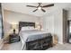 Bedroom featuring a rustic bed frame, a ceiling fan, and cozy bedside lighting at 150 S Harrison St # 9, Denver, CO 80209