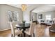 Dining area with wood floors flowing into the living room with a large window at 150 S Harrison St # 9, Denver, CO 80209