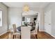 Cozy dining area featuring wood floors, a modern light fixture, and neutral tones at 150 S Harrison St # 9, Denver, CO 80209