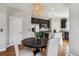 Open-concept dining area with dark cabinets and a kitchen island, plus stylish lighting at 150 S Harrison St # 9, Denver, CO 80209