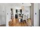 Modern dining area next to kitchen with hardwood floors, dark cabinets, and stylish chandelier lighting at 150 S Harrison St # 9, Denver, CO 80209