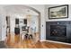 Open concept dining and kitchen area, with hardwood floors, modern lighting and dark cabinets at 150 S Harrison St # 9, Denver, CO 80209