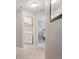 Hallway leading to a laundry room with in-unit washer and dryer, and a bedroom at 150 S Harrison St # 9, Denver, CO 80209