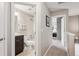 Hallway view of a bathroom and bedroom featuring neutral tones, with carpeted floors at 150 S Harrison St # 9, Denver, CO 80209