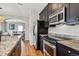 Kitchen with granite countertops, stainless steel appliances, and an open layout at 150 S Harrison St # 9, Denver, CO 80209
