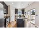 Kitchen featuring granite countertops, dark cabinets, a kitchen island and stainless steel appliances at 150 S Harrison St # 9, Denver, CO 80209