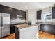 Kitchen with granite countertops, stainless steel appliances, and dark cabinets at 150 S Harrison St # 9, Denver, CO 80209