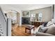 Open-concept living room with hardwood floors, fireplace, and archway to a dining room with a chandelier at 150 S Harrison St # 9, Denver, CO 80209