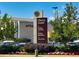 View of a shopping center parking area and signage at 150 S Harrison St # 9, Denver, CO 80209