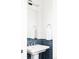 Bathroom with pedestal sink, modern fixtures, and beautiful blue tiled accents at 2321 S Acoma St, Denver, CO 80223