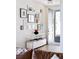 Welcoming entryway with hardwood floors, wall art and a modern console table leading to the front door at 2321 S Acoma St, Denver, CO 80223