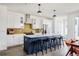 Spacious kitchen features island seating, sleek cabinets, and stylish tile backsplash at 2321 S Acoma St, Denver, CO 80223