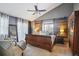 Main bedroom with a large bed, barn door accent wall, and ceiling fan at 7909 Fairfax Ct, Niwot, CO 80503