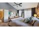 Main bedroom with a large bed, ceiling fan, and gray walls at 7909 Fairfax Ct, Niwot, CO 80503