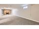 Spacious basement with a brick fireplace and built in shelving unit at 10712 Larson Dr, Northglenn, CO 80233