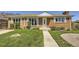 Charming brick home with a well-manicured lawn, inviting entrance, and lovely curb appeal at 10712 Larson Dr, Northglenn, CO 80233