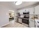 Contemporary kitchen featuring stainless steel appliances and an open layout to the living area at 10712 Larson Dr, Northglenn, CO 80233