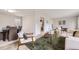 Open-concept living room with stylish furniture and easy access to dining area at 10712 Larson Dr, Northglenn, CO 80233