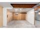 Unfinished basement with wood paneling and exposed beams offers potential for customization at 2336 S Dawson Way, Aurora, CO 80014