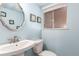 Bathroom featuring a vanity sink, toilet, and blue walls at 2336 S Dawson Way, Aurora, CO 80014