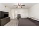 Bedroom with neutral carpet, ceiling fan, and dresser with TV at 2336 S Dawson Way, Aurora, CO 80014