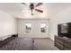 Bedroom with neutral carpet, ceiling fan, and two windows at 2336 S Dawson Way, Aurora, CO 80014