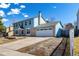 Two-story home with brick and blue siding, attached garage and driveway on a clear, sunny day at 2336 S Dawson Way, Aurora, CO 80014