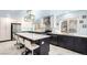 Renovated kitchen with stainless steel appliances, white cabinets and large island with seating at 2336 S Dawson Way, Aurora, CO 80014