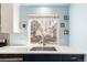 Kitchen sink overlooks the backyard, with stylish decor and white countertops at 2336 S Dawson Way, Aurora, CO 80014