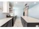 Bright kitchen boasts white countertops, stainless steel appliances, and modern lighting at 2336 S Dawson Way, Aurora, CO 80014