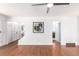 Spacious, brightly lit living room with hardwood floors, ceiling fan, and white walls at 2336 S Dawson Way, Aurora, CO 80014