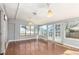 Bright sunroom with hardwood floors, many windows, and access to the backyard at 2336 S Dawson Way, Aurora, CO 80014