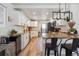 Bright kitchen features granite countertops, a breakfast bar, and ample cabinet space at 8909 S Allison St, Littleton, CO 80128