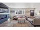 Modern living room with fireplace and large window allowing for ample natural light at 8909 S Allison St, Littleton, CO 80128